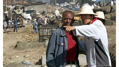 A Chinese construction worker supervises the building of a road in Addis Ababa, Ethiopia.