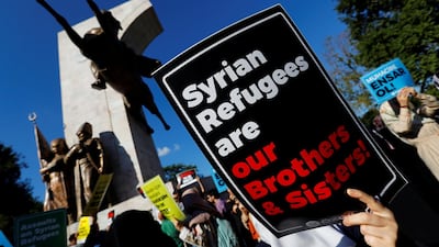 Demonstrators hold placards in support of Syrian refugees during a protest against Turkish government's recent refugee policies in Istanbul. REUTERS