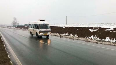 An ambulance drives on a highway, travelling from the direction of a large explosion, in Pampore, Indian-controlled Kashmir. AP