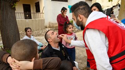 A medical worker administers oral cholera vaccinations in the Akkar district of northern Lebanon. EPA