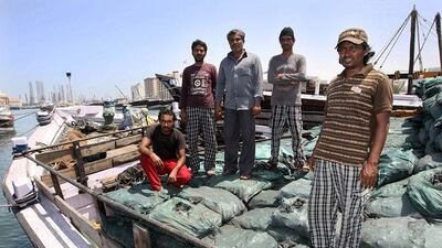 Captain Siddique Mohammed, right, and members of his crew safely back in Sharjah Creek on board the MSV Al Kaderi after escaping from Somali pirates.