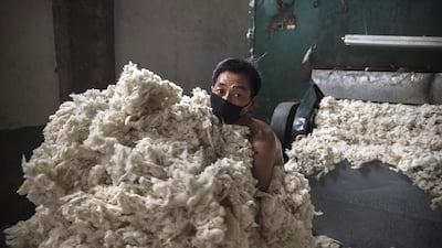 A worker gathers up imported sheep’s wool after it was processed and bleached at a factory near Zhangzhou. China is the major market for Australian wool, with more than 75 per cent of Ausralia's wool clip output exported to China for processing. Kevin Frayer / Getty Images