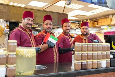 Muamar Al Attar, left, with his team at Balbola Balbalooky in the Syria pavilion at Global Village in Dubai. Pawan Singh for The National