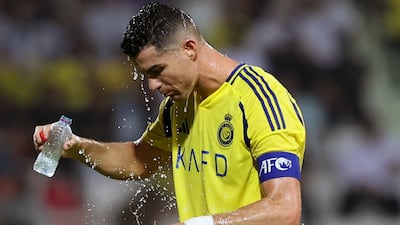 Al Nassr's Cristiano Ronaldo cools off during the match. Chris Whiteoak / The National