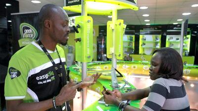 The sale and leaseback deal would accelerate Etisalat’s rollout of 2G, 3G and 4G coverage across Nigeria. Above, an Etisalat staff attends to a customer in Lagos. Akintunde Akinleye for The National