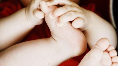 Baby boy concentrating on his toes