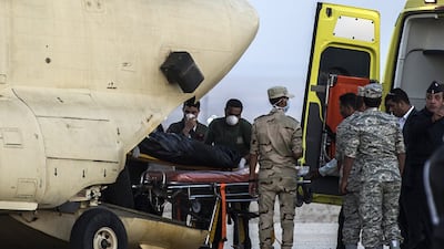 Egyptian paramedics load the bodies of Russian victims of a passenger plane crash in the Sinai Peninsula, into a military plane at Kabret military air base by the Suez Canal. Egypt’s government said 15 bodies have been recovered and transferred to a morgue so far from the site of the crash. Khaled Desouki / AFP