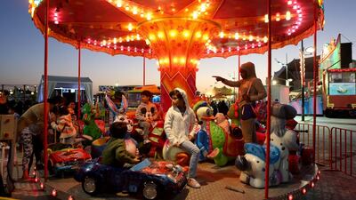 Children enjoy rides at the Six Continents Festival at Khalifa Park in Abu Dhabi yesterday. Sammy Dallal / The National