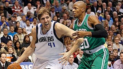 Dirk Nowitzki, left, drives on Boston Celtics guard Ray Allen during the first half of their NBA basketball game in Dallas.