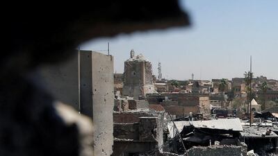 Above, the destroyed Al Hadba minaret at Grand Al Nuri mosque, left, as seen from an Iraqi-held position in Mosul, Iraq. Erik De Castro / Reuters