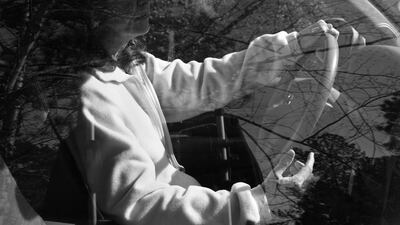 A driver looks into the empty space in her hand where a smartphone would be while driving. Courtesy Eric Pickersgill