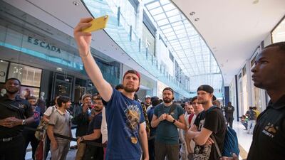 Vladislav Mikheev, in the red cap, flew in from Russia. He was the first to get his new iPhone XS. Leslie Pableo / The National