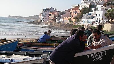 Fishermen enjoy a chat in the late afternoon on Taghazout beach, which attracts surfers from all over the world.