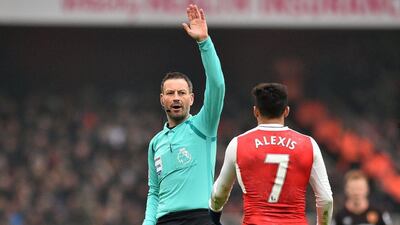 English referee Mark Clattenburg gestures to Arsenal’s Alexis Sanchez. Glyn KIRK / AFP