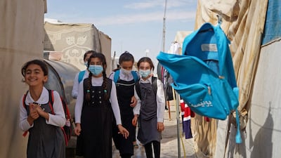 Yazidi girls walk to class on the first day of school at a displaced persons camp in the Sharya area, about 15 kilometres from the city of Dohuk in Iraqi Kurdistan. AFP