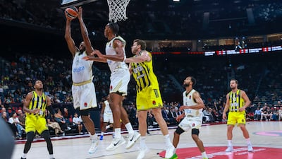 Thomas Walkup (11) of Dubai Basketball rebounds the ball.