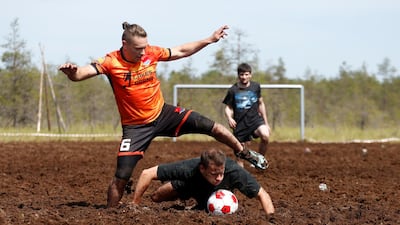 Members of Saint Petersburg Lakes and Koryaga teams compete in the Swamp Football Cup of Russia in the village of Pogi in Leningrad Region, Russia June 16, 2018. Anton Vaganov / Reuters