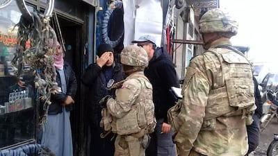 US troops based around the Syrian town of Manbij speaking with residents. AP