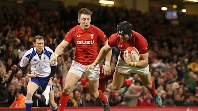 Leigh Halfpenny dives over the line to score Wales their third try in the win over Scotland on Saturday. Paul Harding / PA