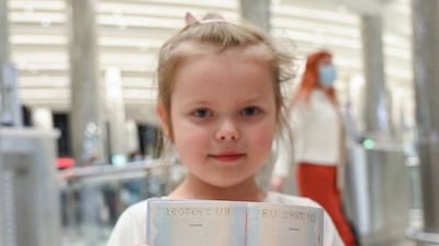 A young girl is pleased with her new stamp.