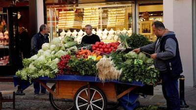 A street vendor stands next to his stall in front of a jewellery shop in Istanbul, Turkey. The country entered its first recession in a decade following a currency rout last year that touched off inflation. Reuters