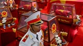 A soldier stands beside coffins containing the remains of fallen soldiers at Le Thi Rieng Park in Ho Chi Minh City, Vietnam. AFP
