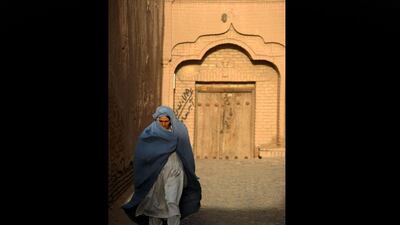 An Afghan woman walks in a walkway in the city of Herat. Aref Karimi / AFP Photo