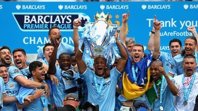 Vincent Kompany of Manchester City lifts the Premier League trophy at the end of their season finale victory over West Ham United at the Etihad Stadium on Sunday. Alex Livesey / Getty Images