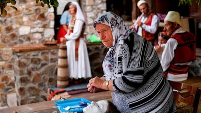 Sefitagic applies a face painting to a bride. AFP