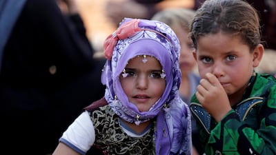 Newly displaced Syrian children react after arriving in a refugee camp in Atimah village, Idlib province, Syria September 11, 2018. Reuters