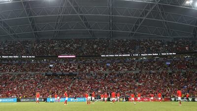 Arsenal players warm up in front of the crowd at Singapore's National Stadium on Saturday before their Asia Trophy final match against Everton. Lionel Ng / Getty Images