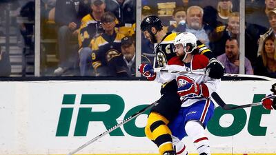 Montreal’s David Desharnais, right, gets physical with the taller Zdeno Chara of Boston. Jared Wickerham / AFP