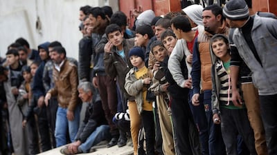 Iraqis wait to receive food aid parcels during a government distribution in the Al Baker neighbourhood of eastern Mosul on November 30, 2016. Thomas Coex/AFP