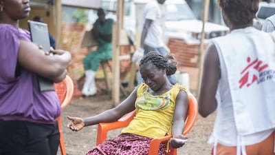 A woman in Guinea grieves for her younger sister, who died two days after being diagnosed with Ebola. Sylvain Cherkaoui / Cosmos
