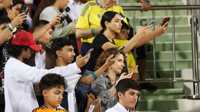 Fans try and get a picture of Cristiano Ronaldo as he enters the pitch.