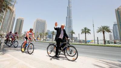 Boris Johnson, the mayor of London, rides a bicycle with the RIDE Shop team outside Pavilion, Downtown Dubai. Sarah Dea / The National