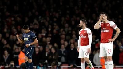 Alexis Sanchez, left, celebrates after scoring Manchester United's opening goal against Arsenal. AP Photo
