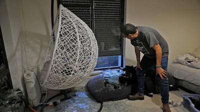 An Israeli man checks debris at a house on the outskirts of Jerusalem, where a rocket fired from the Gaza Strip fell. AFP