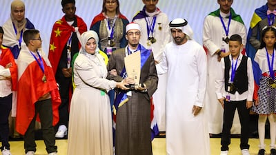 Sheikh Hamdan bin Mohammed, Crown Prince of Dubai, Deputy Prime Minister and Minister of Defence, presents Mohammed Ahmed Hassan from Egypt with the award for Reading Champion in the People of Determination