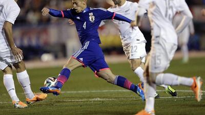 Keisuke Honda and Japan beat New Zealand 4-2. They'll play in Group C at the 2014 World Cup with Colombia, Greece and Ivory Coast. Shuji Kajiyama / AP