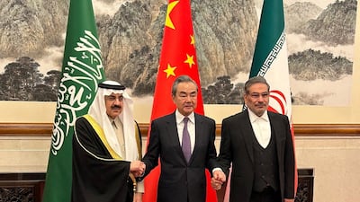 China's top diplomat Wang Yi is flanked by Saudi Minister of State and national security adviser Musaed bin Al Aiban, left, and Iranian Admiral Ali Shamkhani, secretary of the Supreme National Security Council, in Beijing on Friday. Reuters