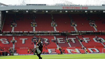 Fans leave the the Stretford End and the Sir Alex Ferguson stand (unseen) following an evacuation of both stands ahead of the Premier League match between Manchester United and Bournemouth at Old Trafford in Manchester, north west England, on May 15, 2016. Oli Scarff / AFP