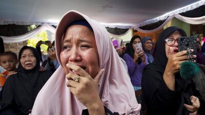 A family cries during funeral of of one of the passengers at Sukodono village in Sidoarjo. Reuters