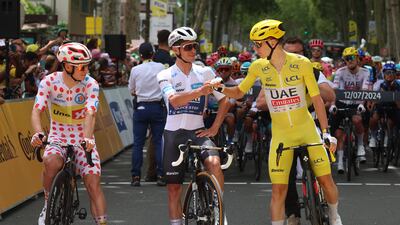 From left, Uno-X Mobility's Jonas Abrahamsen, UAE Team Emirates' Tadej Pogacar and Soudal Quick-Step's Remco Evenepoel are seen before the start of stage 13. Reuters