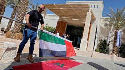 The flags of the nations taking part in the Negev Summit are set up outside the Kedma Hotel. AFP