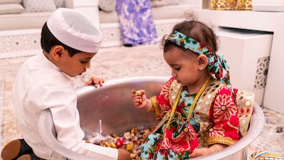 Rashid and Lulua with the large aluminum vessel of treats