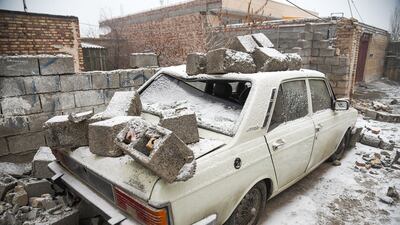 A vehicle covered by rubble. AFP