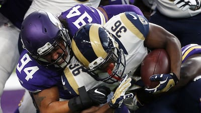 Los Angeles Rams running back Aaron Green is tackled by Minnesota Vikings defensive end Justin Trattou during a pre-season game last week. Jim Mone / AP