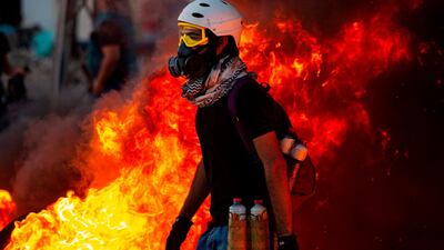Iraqi demonstrators gather near burning tyres during a protest near the governor's residence in the southern city of Basra. AFP