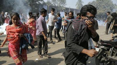 Protesters run for safety as the policemen shoot tear shells to disperse them during a protest against the Rampal coal-fired power plant, near Shahbag, Dhaka, Bangladesh, 26 January 2017. EPA